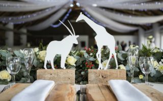 Two White Napkins Across White Silhouette of Animals