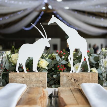 Two White Napkins Across White Silhouette of Animals