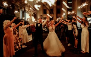 Happy Friends and Newlywed Couple Celebrating Wedding at Night