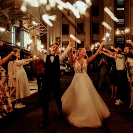 Happy Friends and Newlywed Couple Celebrating Wedding at Night