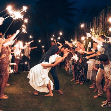 Loving Newlywed Couple Kissing among Wedding Guests