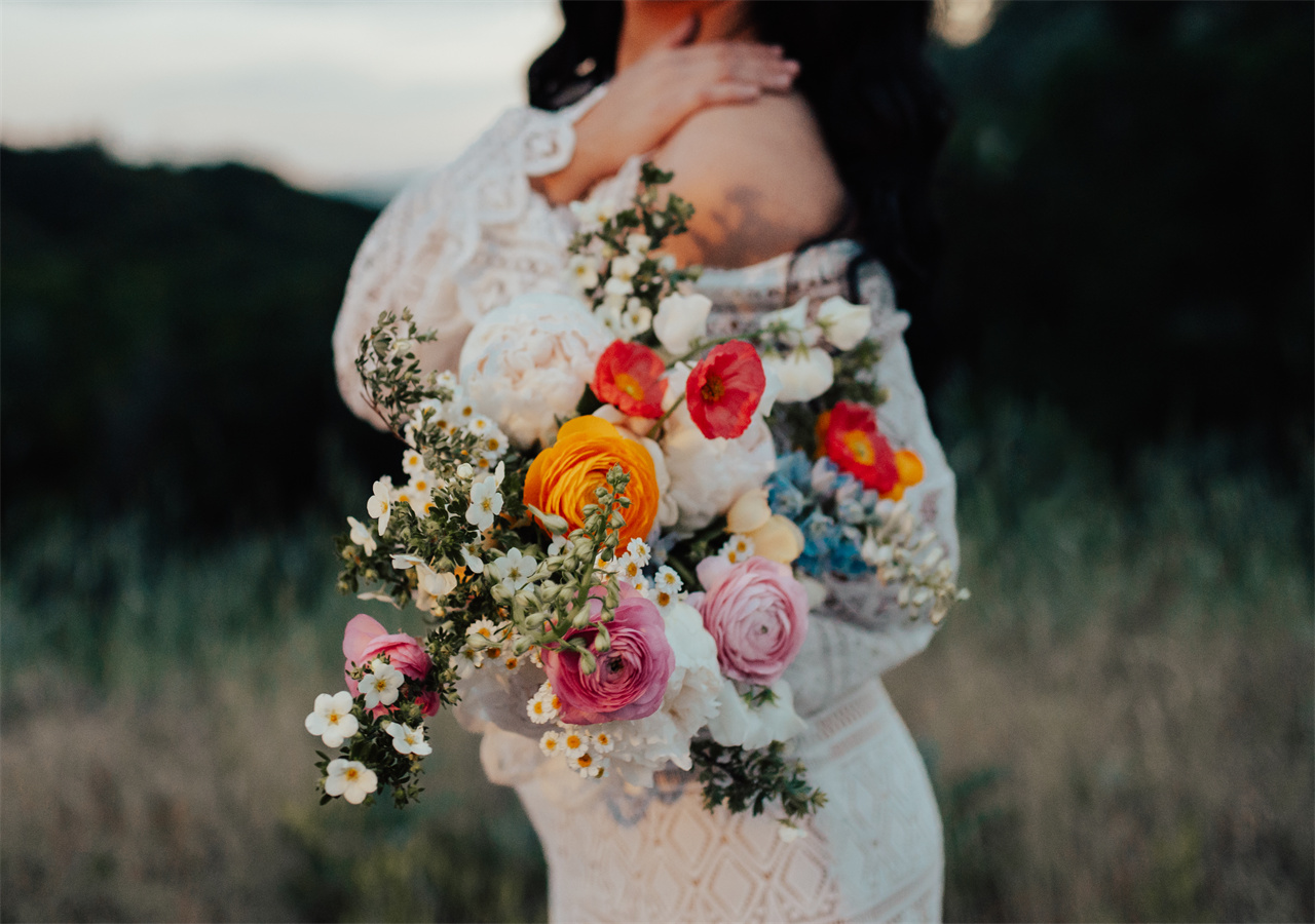 A graceful lady is holding a bouquet of flowers.