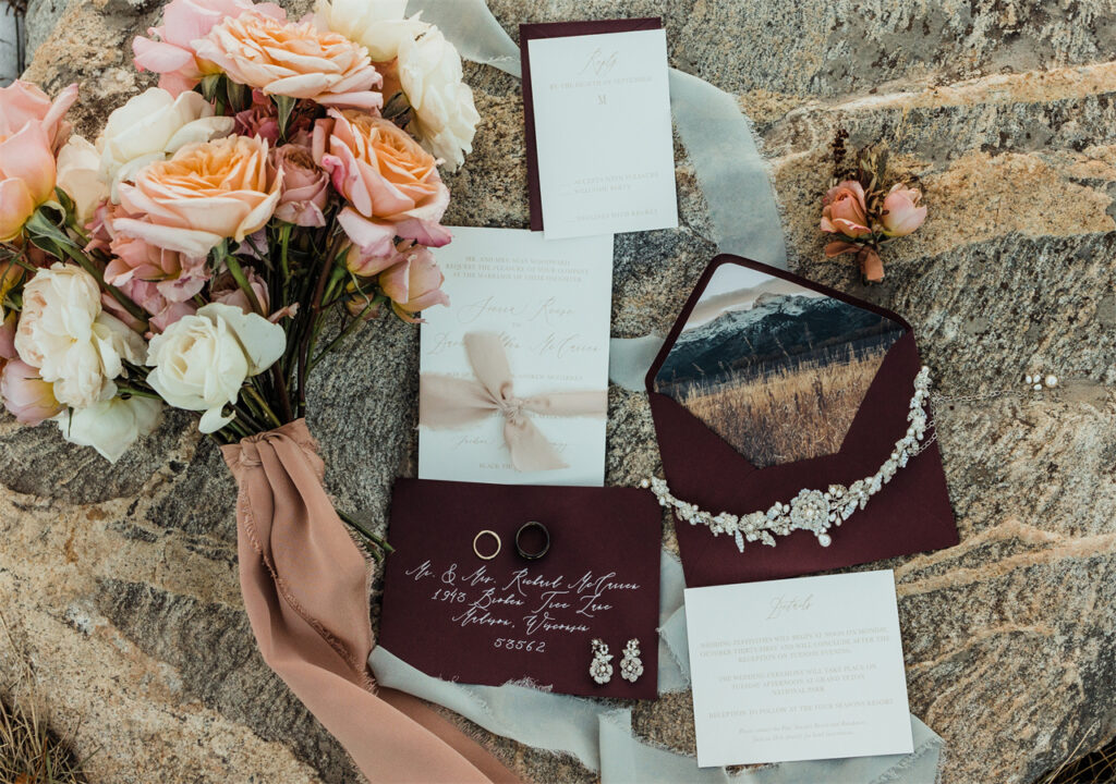 There is a wedding invitation on the table and it is also decorated with beautiful bouquets, which represents happiness.