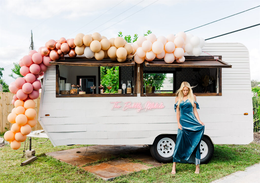 A bridesmaid takes photos while standing in front of the dining car