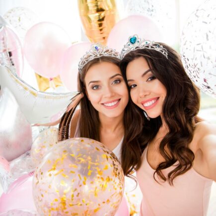 A beautiful bride was taking a selfie with her friend, both smiling happily.