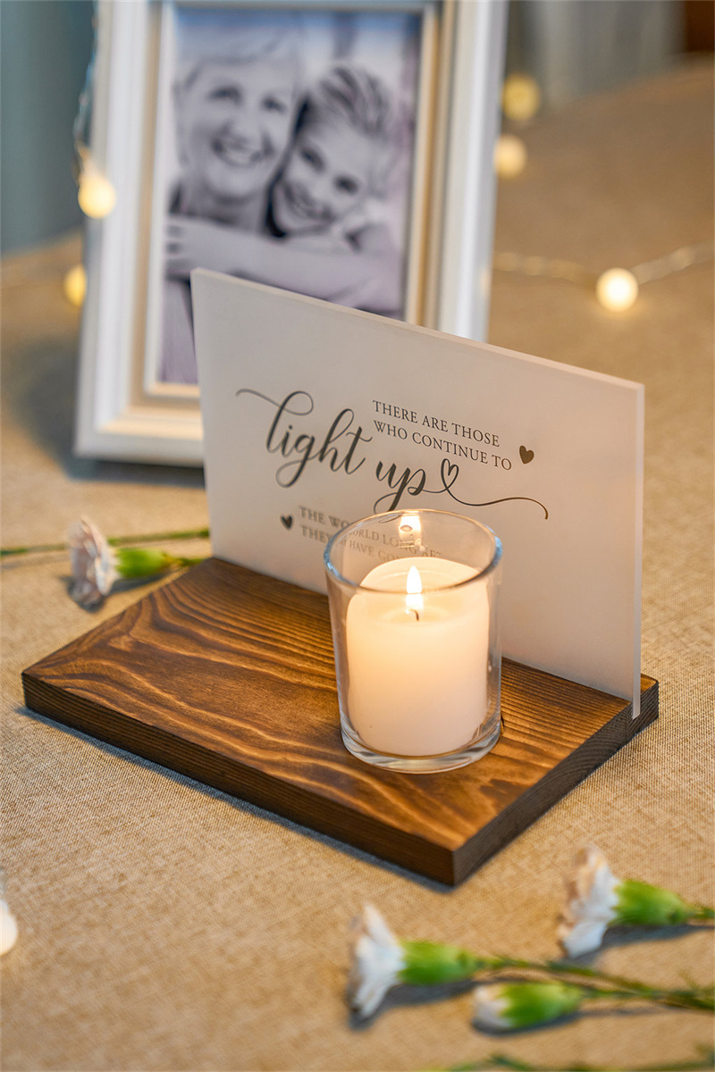 An AW Signs Wedding Candle Holder emitting a warm glow, with elegant lettering, casting soft light onto a romantic setting.