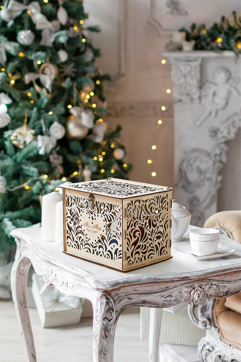  An AW Wood Hollow Gift Card Box with intricate cut-out designs, placed atop an antique wooden table.