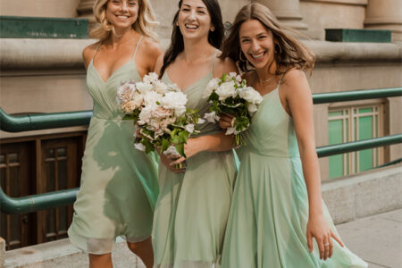 Bridesmaids in light green skirts with bouquets