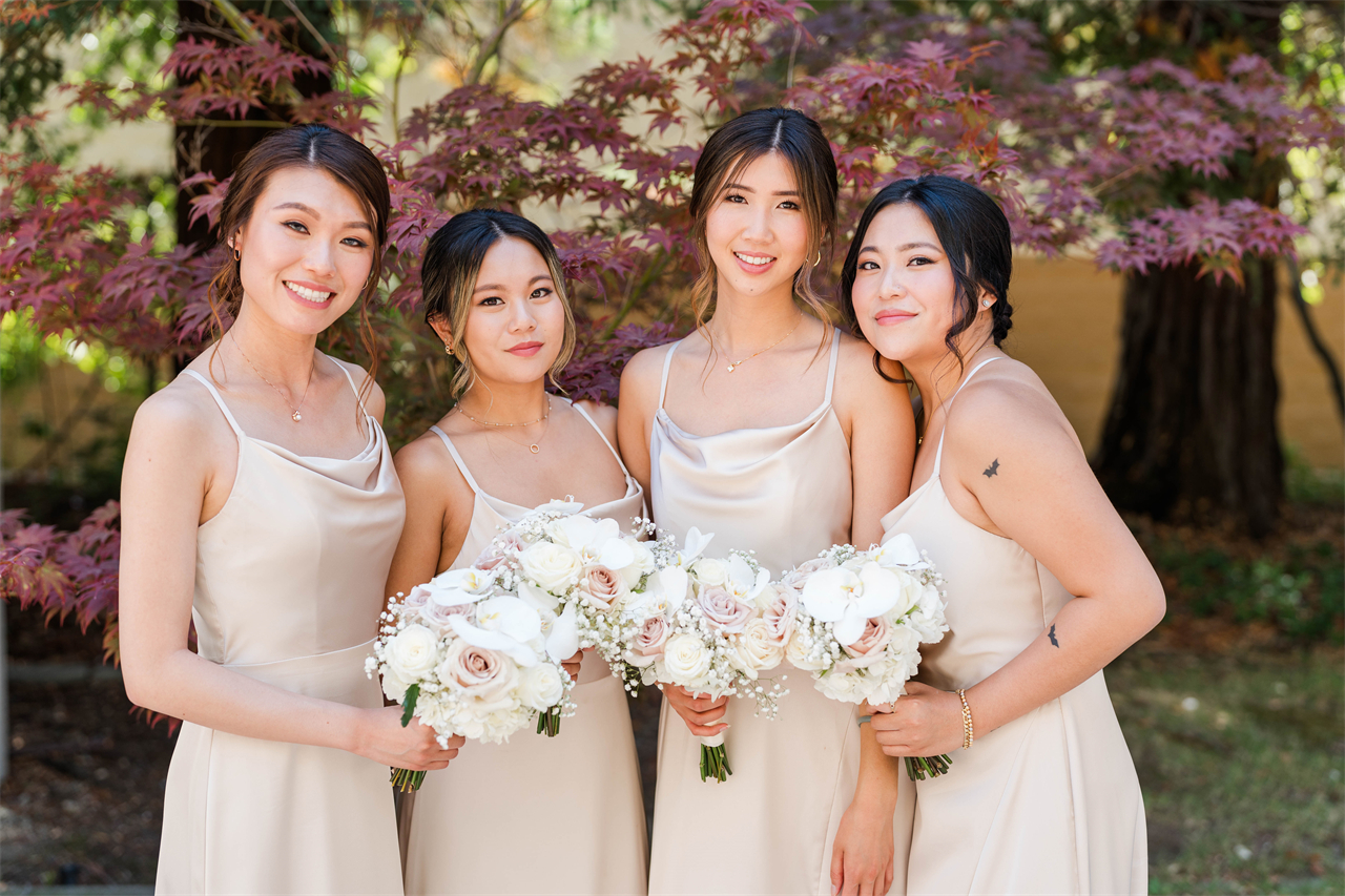 Bridesmaids in champagne dresses, smiling brightly