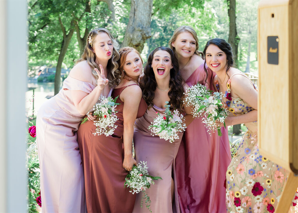 Bridesmaids in colorful dresses posing for a photo.