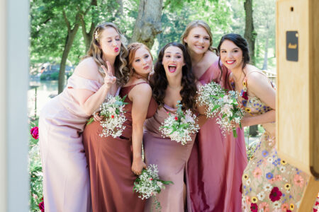 Bridesmaids in colorful dresses posing for a photo.