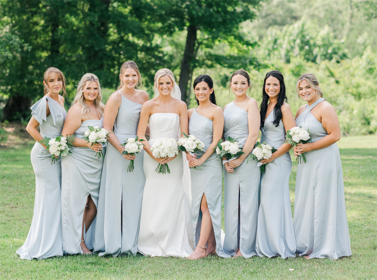 The bride with her bridesmaids in light blue dresses.