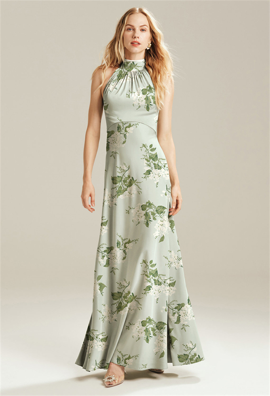 Model wearing a high-neck green floral print dress.