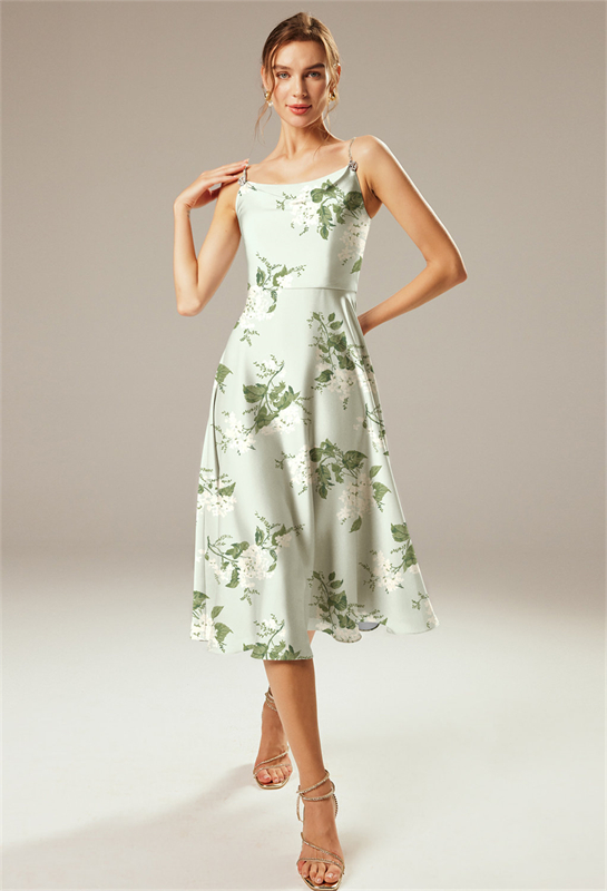 Model wearing a green floral print midi dress with thin straps.