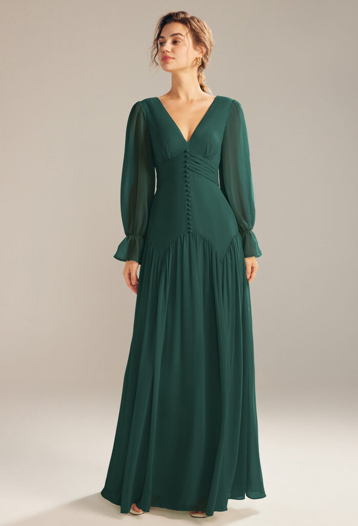 Woman in a long-sleeve, dark emerald bridesmaid dress.