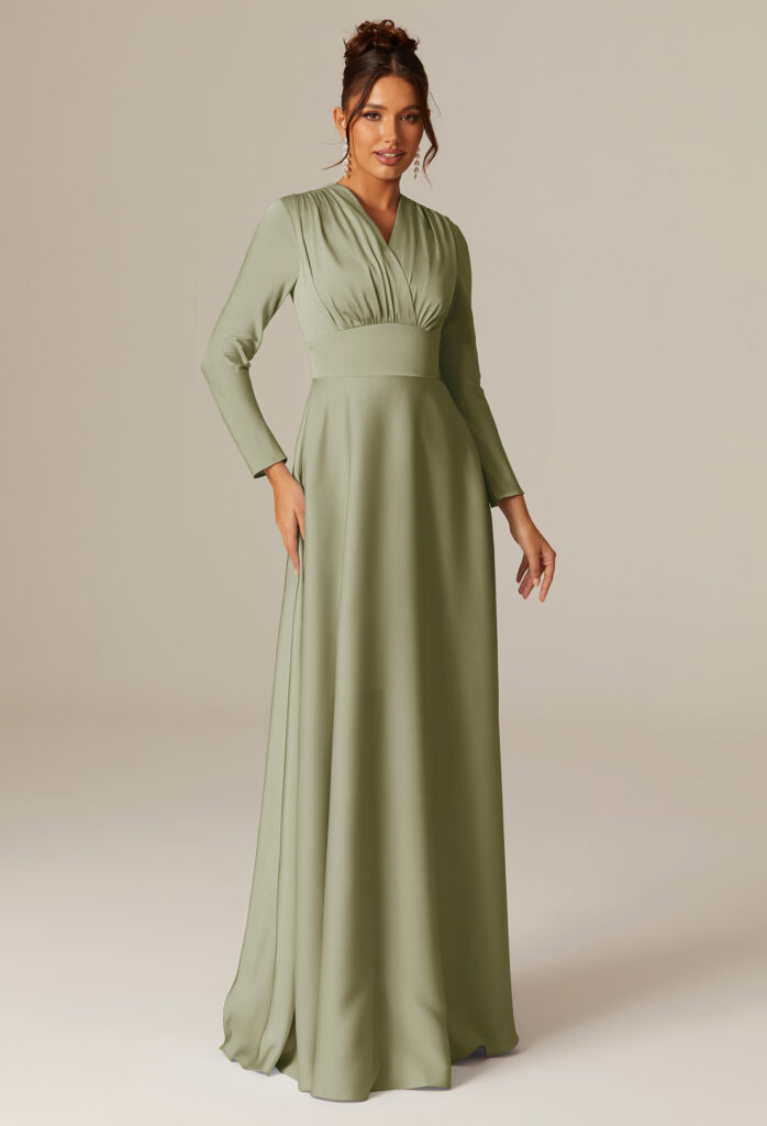 Woman in a long-sleeve, sage green bridesmaid dress.