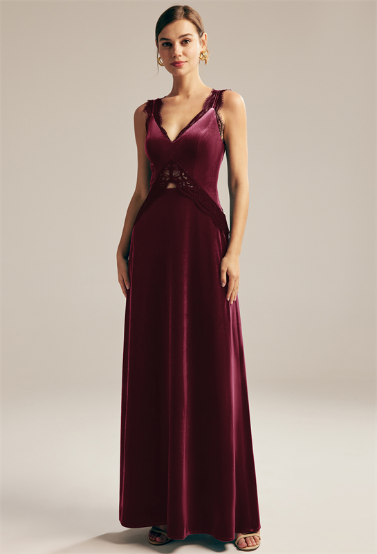 Woman in a burgundy velvet gown with lace detailing and a V-neckline.