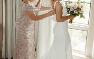 The bride gets ready with the help of loved ones.