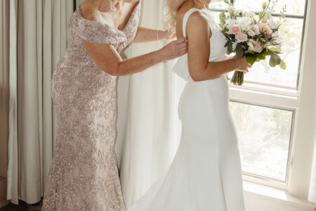 The bride gets ready with the help of loved ones.